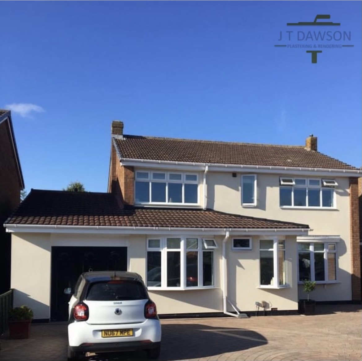 Rendered detached house with garage under a blue sky, by J T Dawson