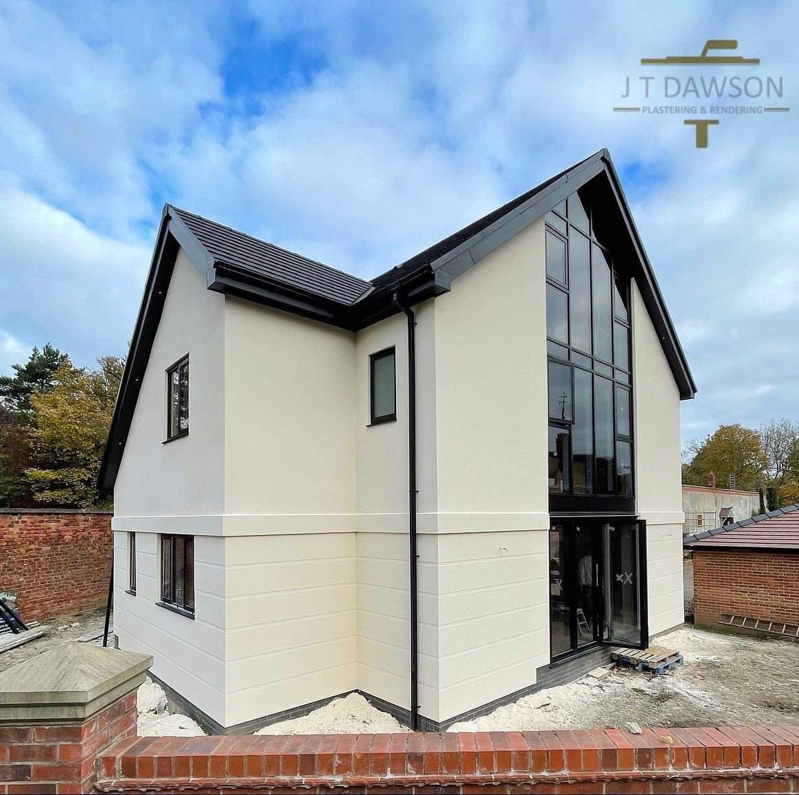 Rendered house with a tall glazed gable, by J T Dawson